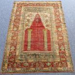 A Turkish silk prayer rug (third quarter 19th century); red mihrab with two vertical columns on a