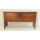 A late 17th/early 18th century boarded oak chest: the hinged lid with chip-carved ends and opening