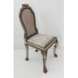 An 18th century style (probably 19th century) salon chair: the rattan cane back surmounted by a