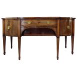 A serpentine-fronted mahogany and ebony strung sideboard: central bow-fronted drawer above a further