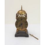 An early 20th century brass lantern clock modelled as a 17th century original:  high arched domed