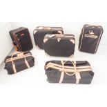 A five-piece set of Classique Noir luggage by the French Luggage Company of the USA and a similar