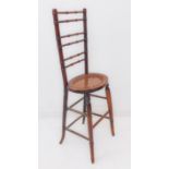 An early 19th century stained-wood child's deportment chair: the verticals and horizontal back-
