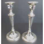 A pair of weighted table candlesticks in neoclassical style, assayed Sheffield 1905, inscribed and