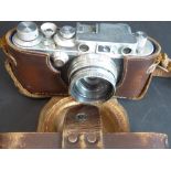 A circa 1940  LEICA D.R.P. Ernst Leitz Wetzlar camera, no. 347765, with Summitar f = 5 cm 1 : 2 lens