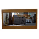 A large solid-oak-framed wall-hanging looking glass. (Frame size 153.5 x 85 cm)