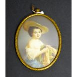 An early 20th century gilt-metal-framed oval portrait miniature on ivory, a beautiful young lady