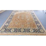 A large Persian Tabriz: burnt amber ground with scrolling foliage, large duck blue main border