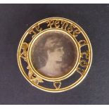An unusual circular 18-carat yellow gold miniature photograph frame: pierced border with three