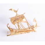 A Greek 18ct yellow gold brooch: in the form of a classical Greek trireme, the sail with an