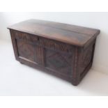 A 17th century oak chest: two-plank moulded top opening to reveal a right-hand candle box and the