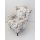 A upholstered armchair: studded back and arm fronts, decorated with lepidoptery and latin names,
