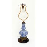 A brass-mounted blue-and-white table lamp on circular Chinese stand: double-gourd form with brass