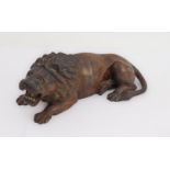 A 19th century carved wood recumbent lion, probably after the Antique (29.5 cm)