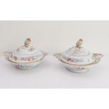 A pair of 19th century two-handled serving tureens: each with a gilded bud and leaves finial above