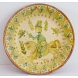 A large modern pottery slipware charger painted and glazed in earlier style with a figure riding;