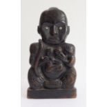 An interesting early 20th century Māori carved wooden tribal figure: mother of pearl roundels as
