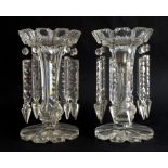 A pair of Victorian clear glass lustres: the printie-cut crown tops on panel-cut stems and petal-cut