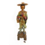 An early 20th century Chinese carved softwood figure of a courtesan: overall polychrome