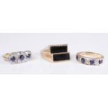 Three assorted rings: a four stone sapphire with diamond-set detail to the 9-carat yellow gold