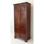 A late 19th/early 20th century gentleman's mahogany wardrobe of slim proportions: the two panelled