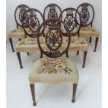 A set of six late 18th century mahogany dining chairs: each with pierced Adamesque oval backs