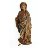 A large 16th or 17th century carved softwood figure of a female saint wearing a long flowing robe