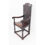 A wainscot chair in 17th century style (probably 19th century): the scrolling crest rail centred