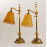 A pair of heavy (weighted) brass table-lamps, height adjustable and with conical amber-coloured