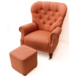 A modern light-pink upholstered buttonback armchair on turned tapering wooden front legs with