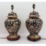 A pair of ceramic table lamps in the Chinese style with gilding against cobalt blue ground, each