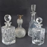 Four quality glass decanters: a modern hand-cut mallet-shaped decanter and stopper ; a hand-cut