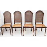 A set of four stained wood and rattan-caned salon chairs (from Heals of London) each raised on