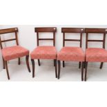 A set of four 19th century mahogany dining chairs with later overstuffed seats and sabre front