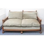 A large early 20th century oak and rattan-caned double sofa: green cushions; barley-twist uprights