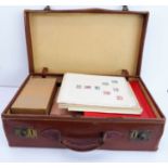 A large leather suitcase full of stamps including: a boxed album of USA first day covers Birds and