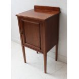 An early 20th century mahogany pot cupboard having single panelled door and raised on square