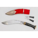 A modern white-metal-mounted Saudi kukri-style knife: carved heavy handle with brass pommel. (Full