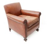 A brown-leather upholstered club chair (circa 1920s): square tapering front legs with castors (80