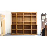 A large late 19th century oak library bookcase with flared cornice above open shelves (270 x 50 x