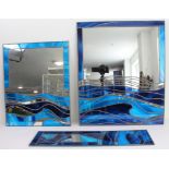 Three modern leaded light wall-hanging mirrors with varying shades of blue glass imitating waves (