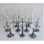 A set of 10 champagne flutes and a set of 8 matching wine goblets. The undersides of both sets