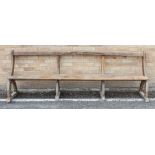 A large late 19th to early 20th century pitch-pine pew in Gothic Reform style. (LWH 265 x 40 x 91