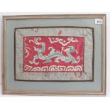 A framed and glazed early 20th century silk Mandarin's sleeve embroidery depicting a dragon