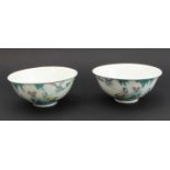 A pair of modern Chinese porcelain bowls in 18th century style: each decorated with an exterior