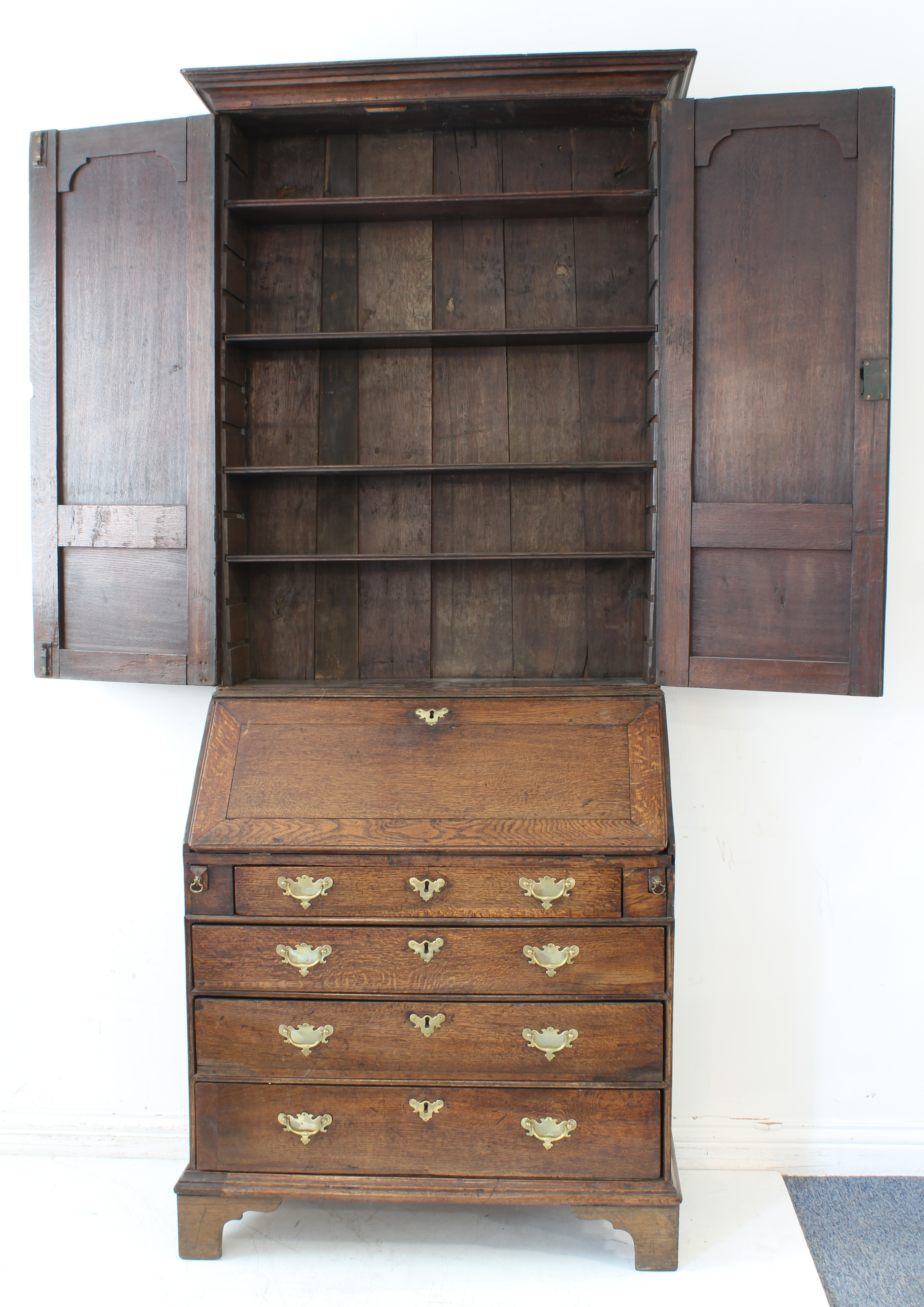 A mid-18th century oak bureau-cabinet: two high fielded panel doors opening to reveal shelves; - Image 3 of 6