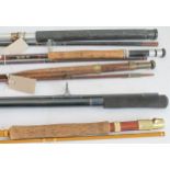 Five canvas cased fishing rods to include: a two-piece fibreglass example; one further two-piece