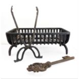 A small fire grate (46 cm wide) together with ironwork tongs and a large decorative early style