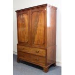 A late 18th century mahogany linen press: short outset cornice above two figured panel doors