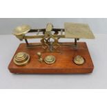 A set of late 19th century inland letter brass postal scales on mahogany plinth base, together